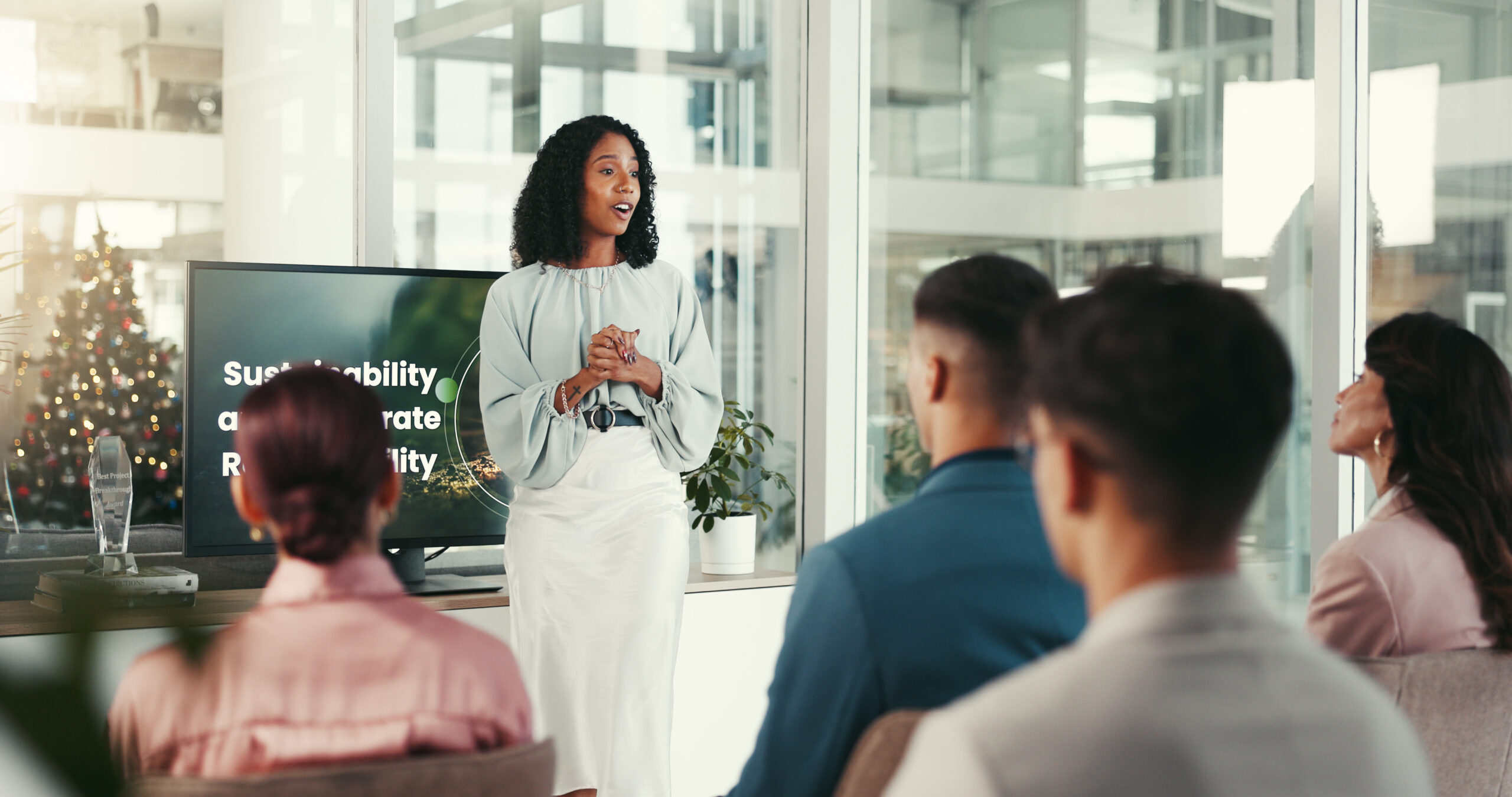 Presentation, audience and screen with businesswoman in office, project training or discussion. Boardroom, employees and corporate trainer with technology for skills development, workshop or meeting.